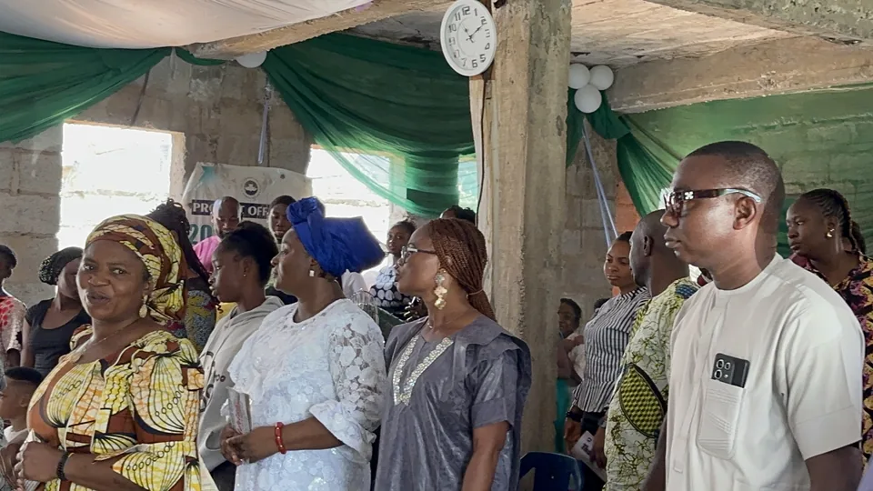 Members of the congregation standing together in worship