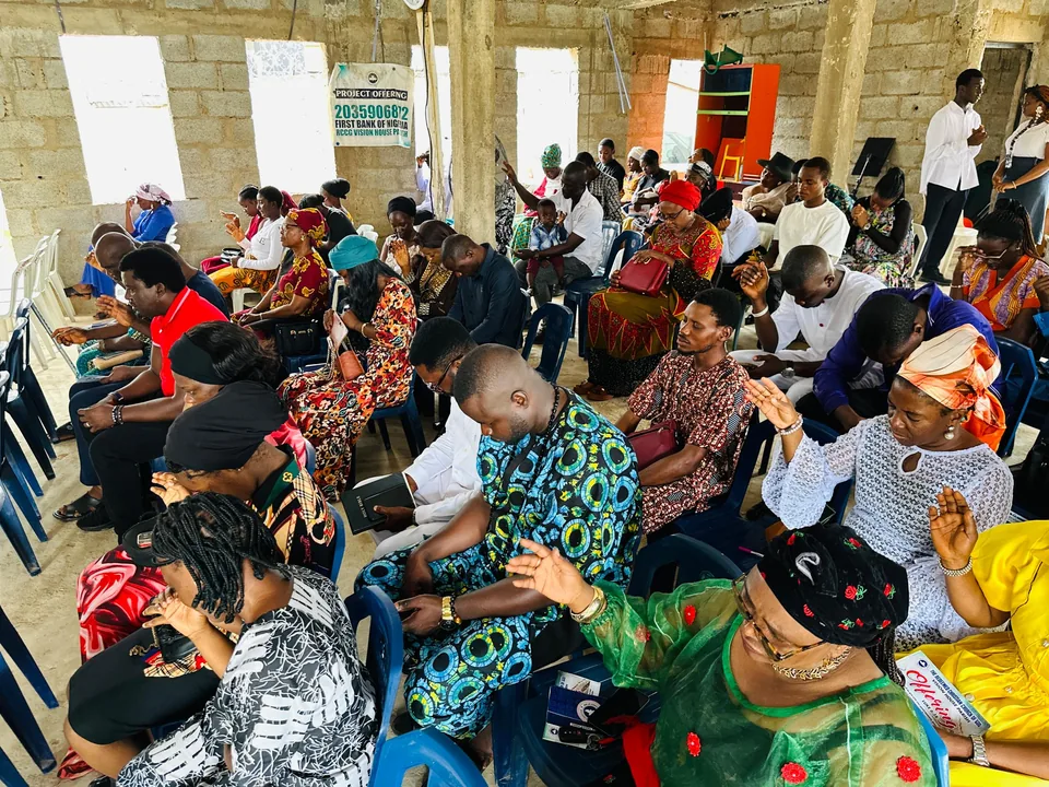 Vision House members seated together in prayer